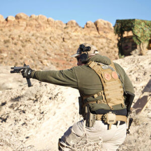 Man in tactical gear shooting a pistol