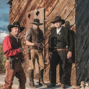 Three men dressed in old western outfits