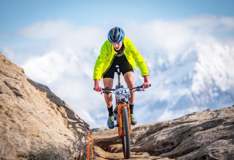 Person mountain biking on rocks