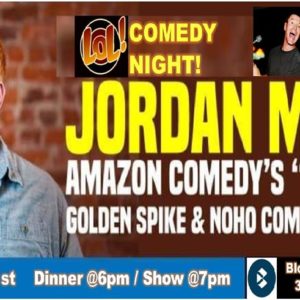 comedian infront of brick wall