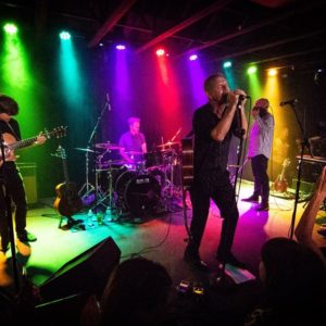 4 men performing on stage