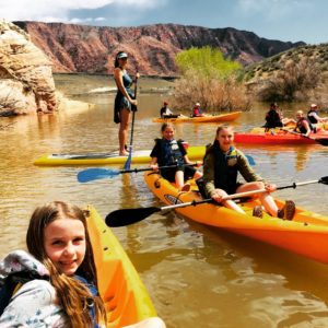 kids on colorful paddleboards, on water